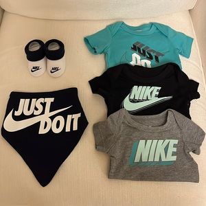 Nike baby onesies, socks, & bib